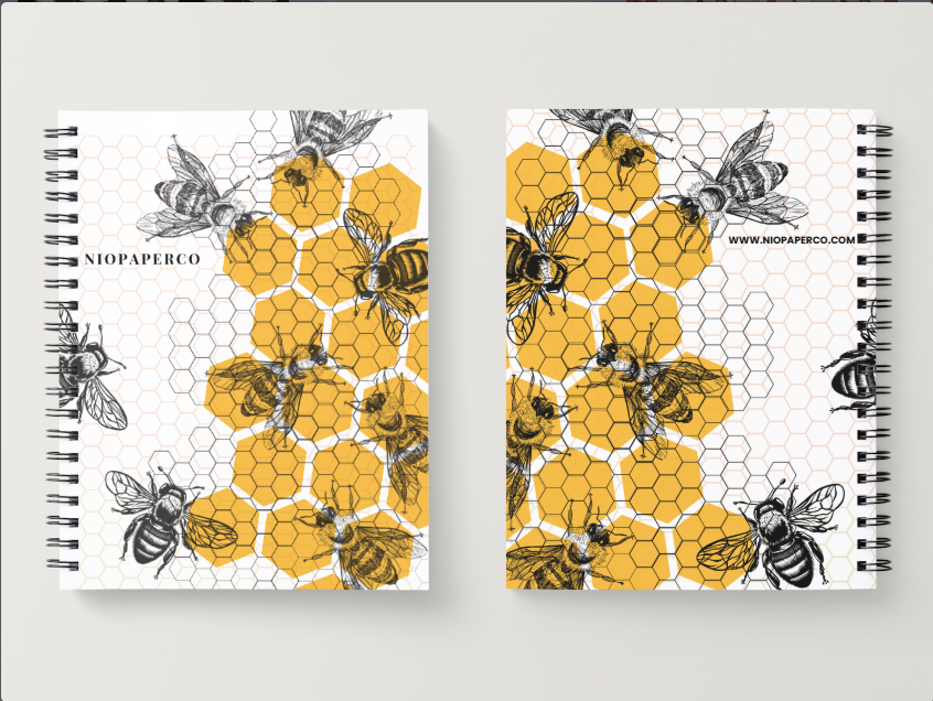 Niopaper Two spiral-bound notebooks with bee and honeycomb pattern on a white background